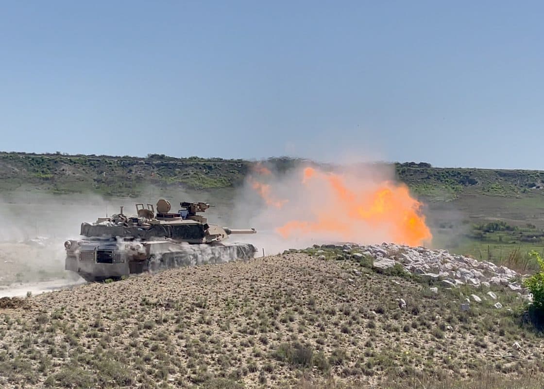 An M1A2 SEPv3 Abrams main battle tank fires a 120mm round during live-fire training at Fort Cavazos, Texas