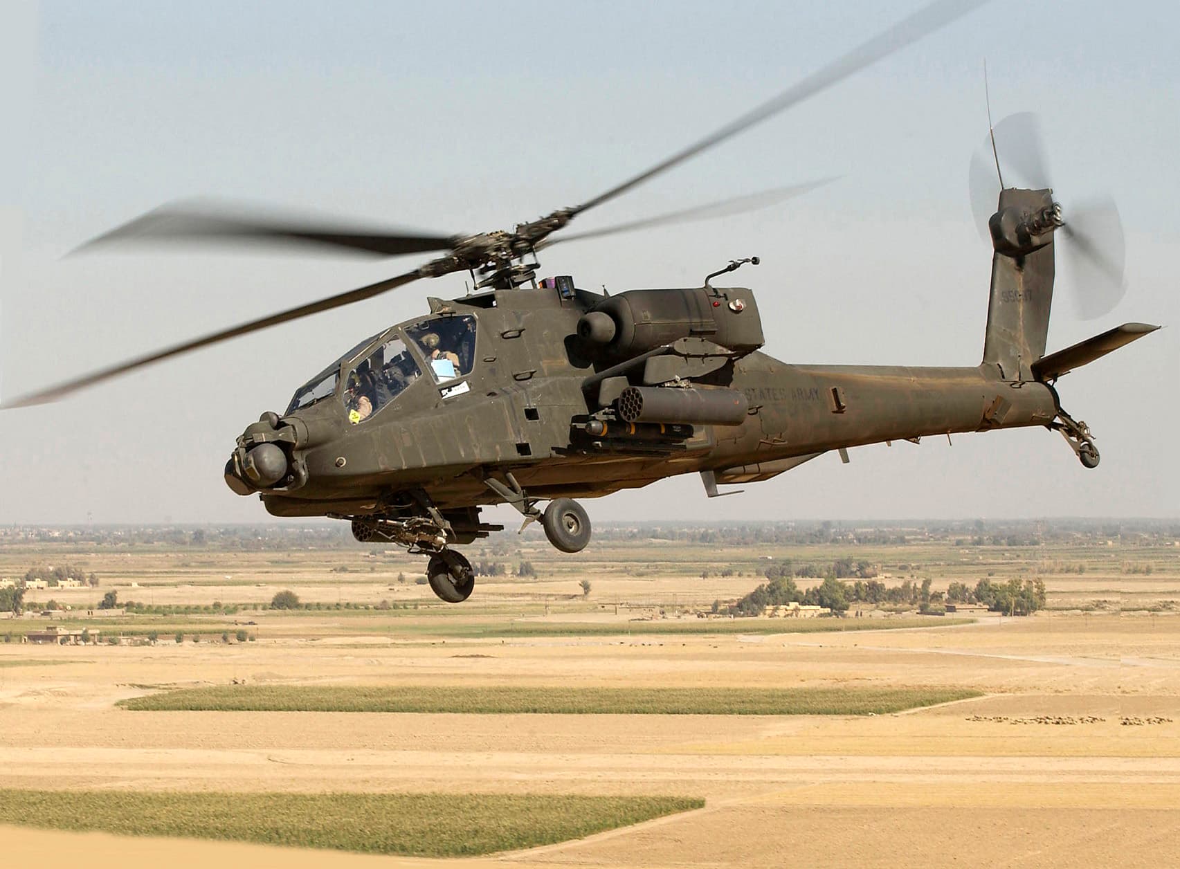AH-64 Apache attack helicopter in flight alongside illustration of Ka-52 Alligator showing their contrasting designs