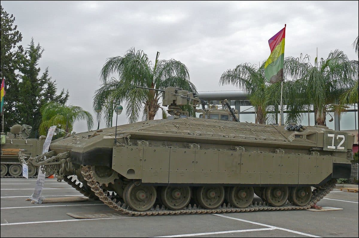 Namer heavy armored personnel carrier in urban terrain showing its Merkava-derived hull and Trophy active protection system