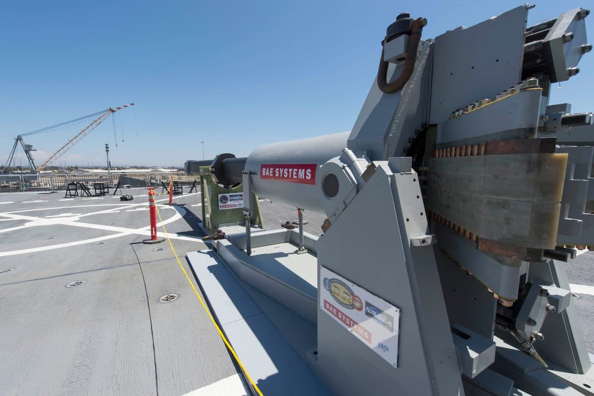 US Navy electromagnetic railgun firing a projectile at the Naval Surface Warfare Center Dahlgren with a bright muzzle flash