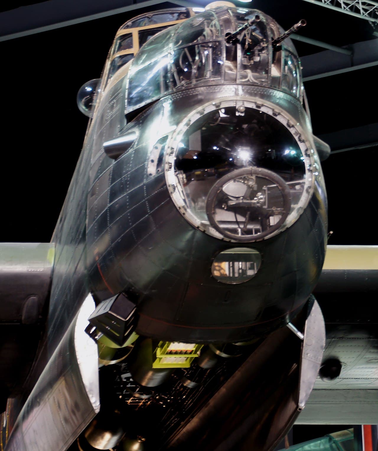 Lancaster bomber nose and front turret section viewed from below in a museum display