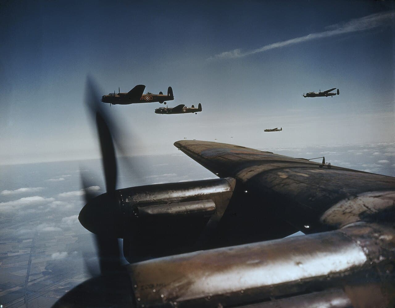Avro Lancasters of RAF Bomber Command in formation, photographed from another Lancaster with spinning propeller visible
