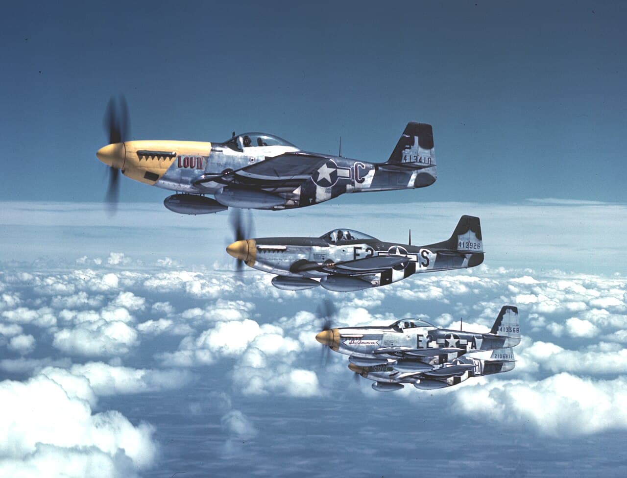 Four P-51 Mustangs of the "Bottisham Four" flying in formation