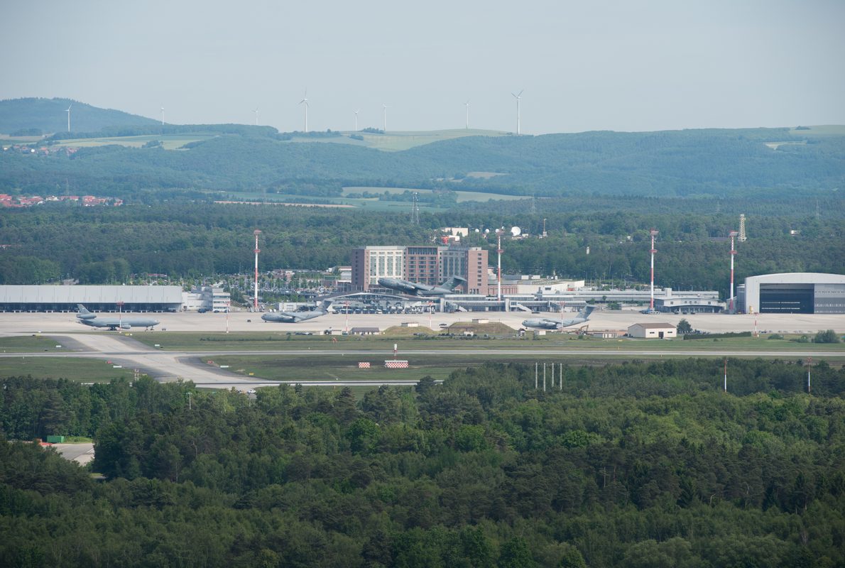 C-130 aircraft on the tarmac at Ramstein Air Base in Germany with control tower