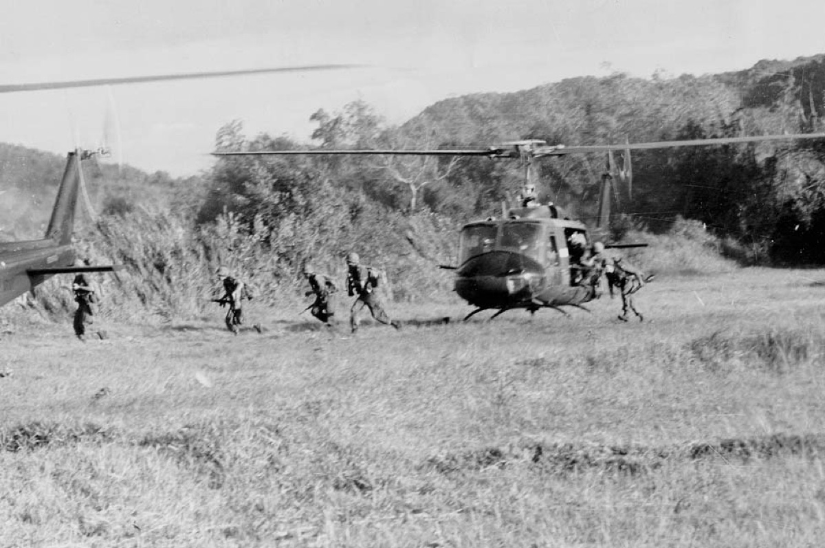 US infantry soldiers disembarking from a Huey helicopter during the Battle of Ia Drang in 1965