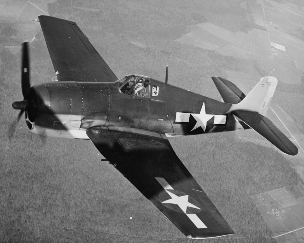 F6F Hellcat on a carrier deck with Pacific Ocean in background