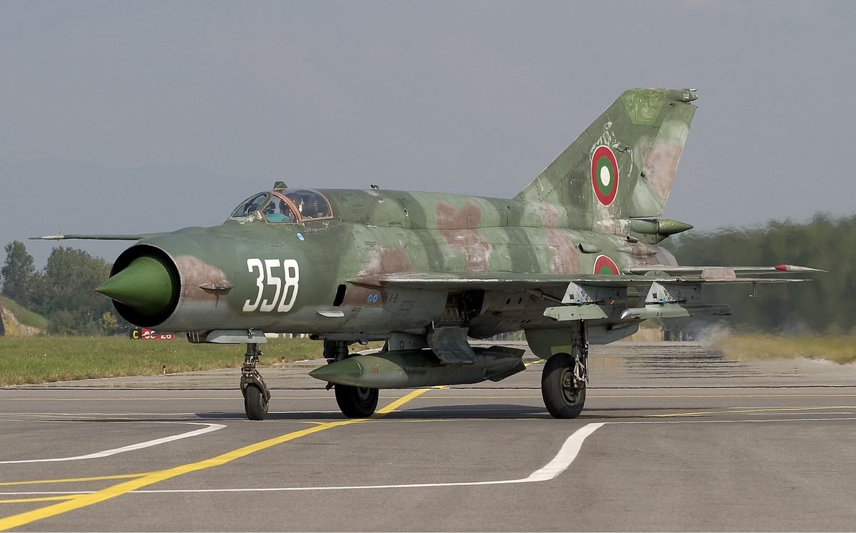 MiG-21 Fishbed in bare metal finish climbing steeply