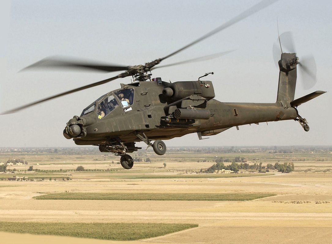 AH-64 Apache attack helicopter firing Hellfire missile at night