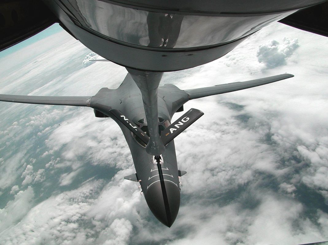 KC-135 Stratotanker refueling an F-16 in mid-air with boom extended