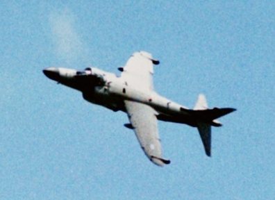 Sea Harrier hovering in vertical takeoff over a Royal Navy carrier