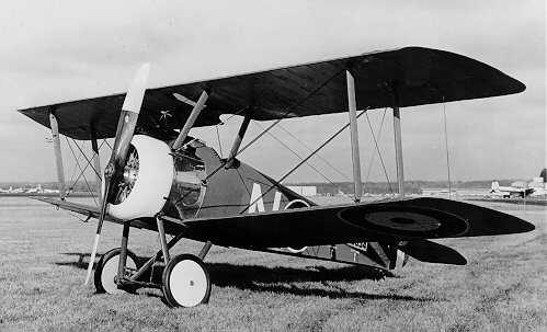 Sopwith Camel biplane in RFC markings flying above World War I trenches