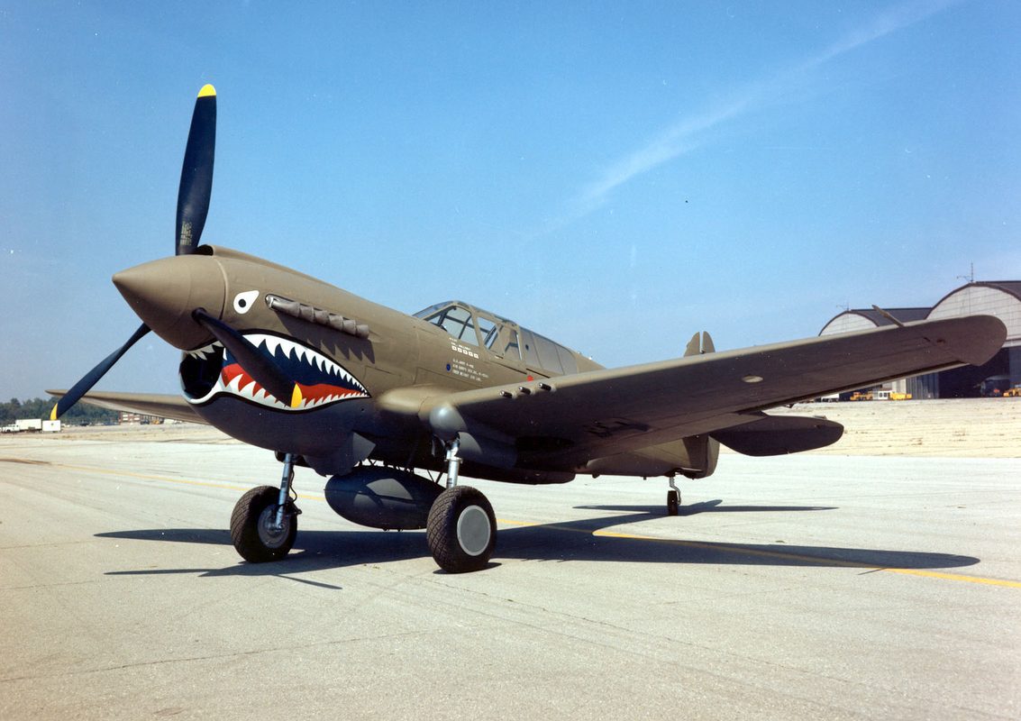 Curtiss P-40 Warhawk in flight showing iconic shark mouth nose art