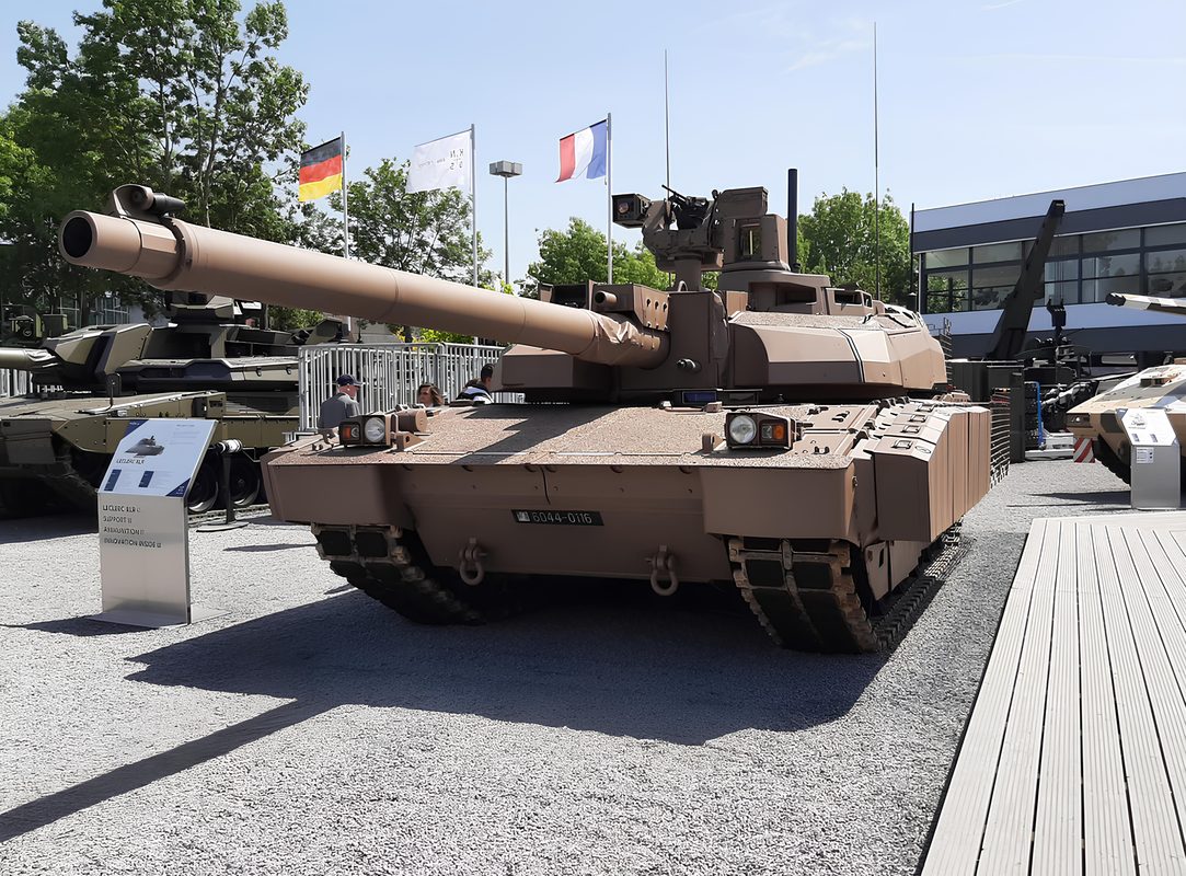French Leclerc main battle tank at high speed with dust trail in desert terrain