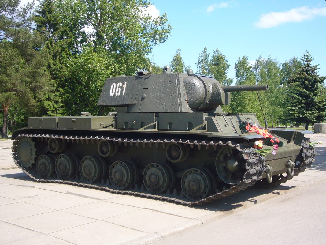 Soviet KV-1 heavy tank with thick cast armor plowing through muddy terrain on the Eastern Front