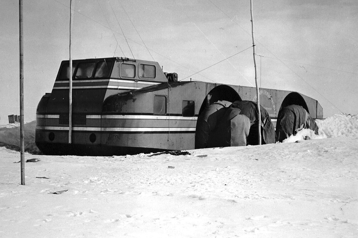 The abandoned Antarctic Snow Cruiser partially buried in snow and ice