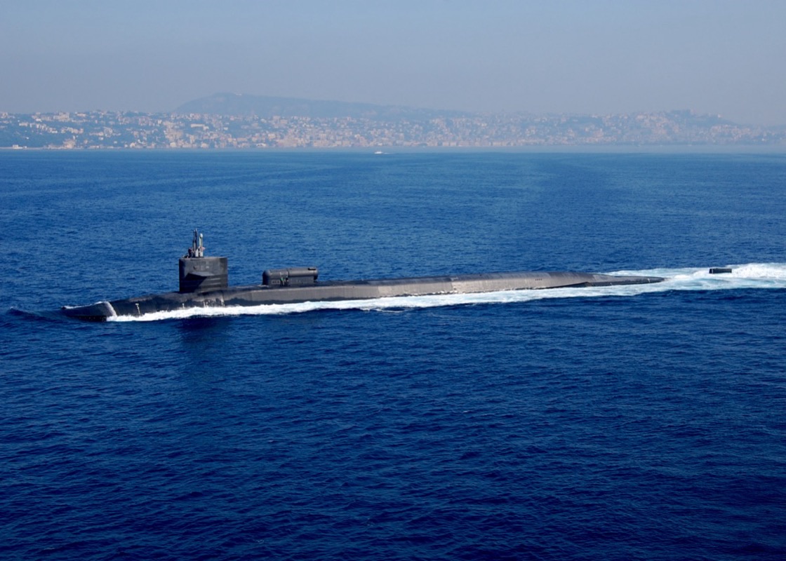 Ohio-class ballistic missile submarine surfacing in deep blue ocean