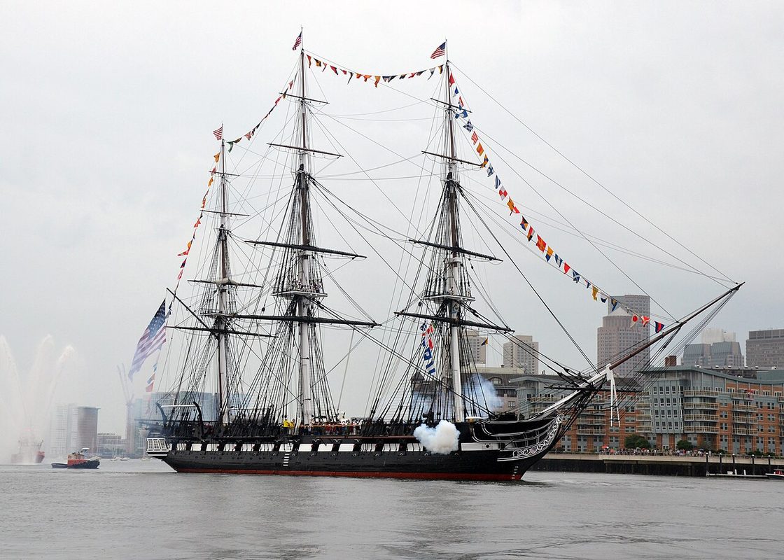 USS Constitution wooden frigate under sail in Boston Harbor