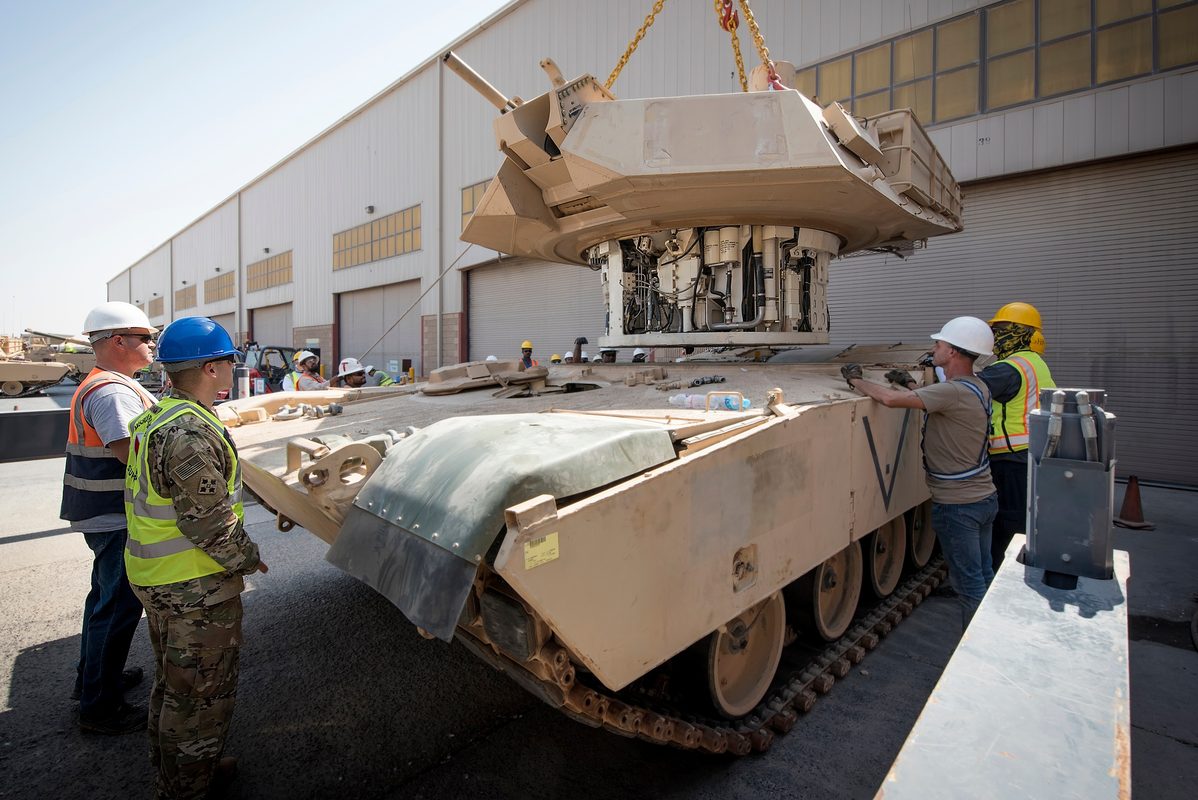 A maintenance crew at Army Prepositioned Stocks-5 in Kuwait performs turret reattachment on an M1A2 Abrams tank