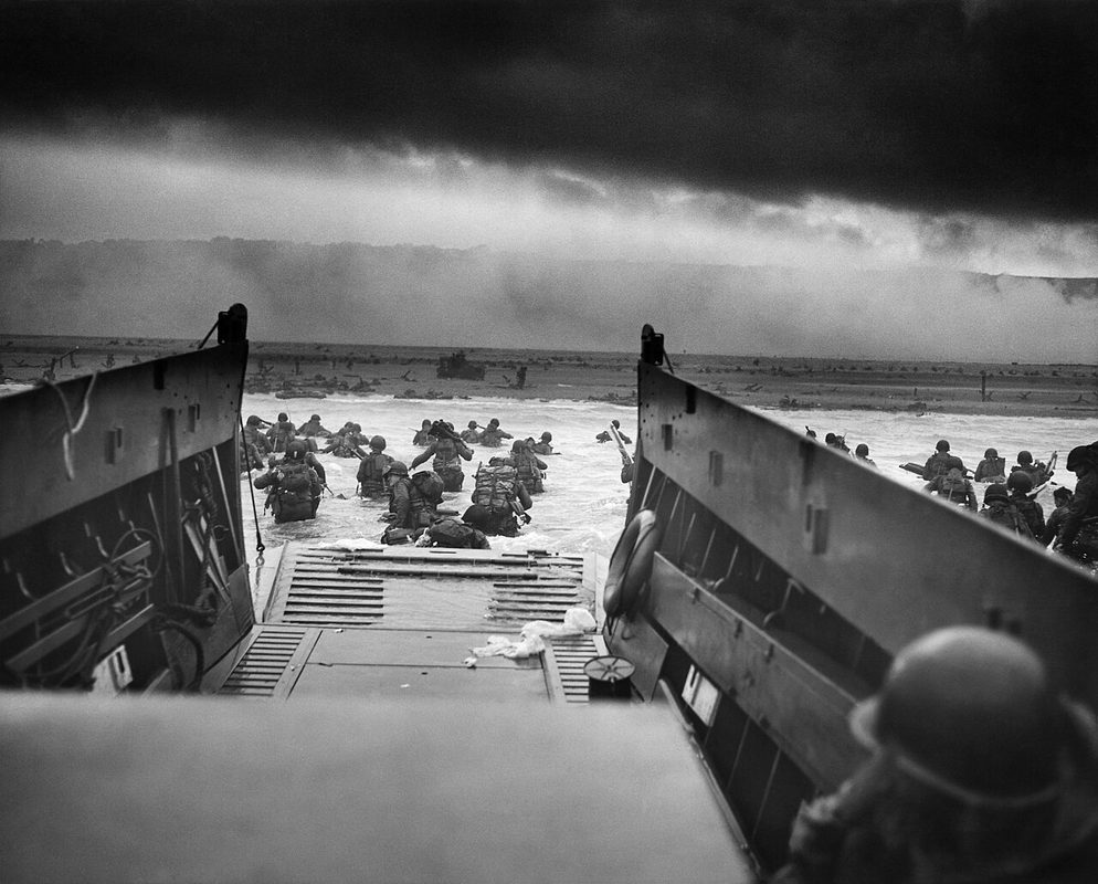 American soldiers wading from a landing craft toward Omaha Beach on D-Day, June 6, 1944