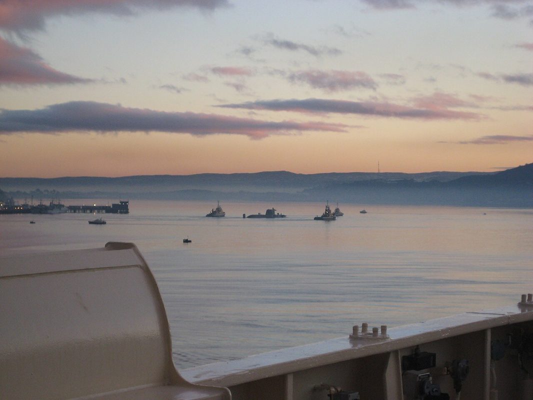 Naval vessels on the Clyde estuary near the submarine facilities at sunset