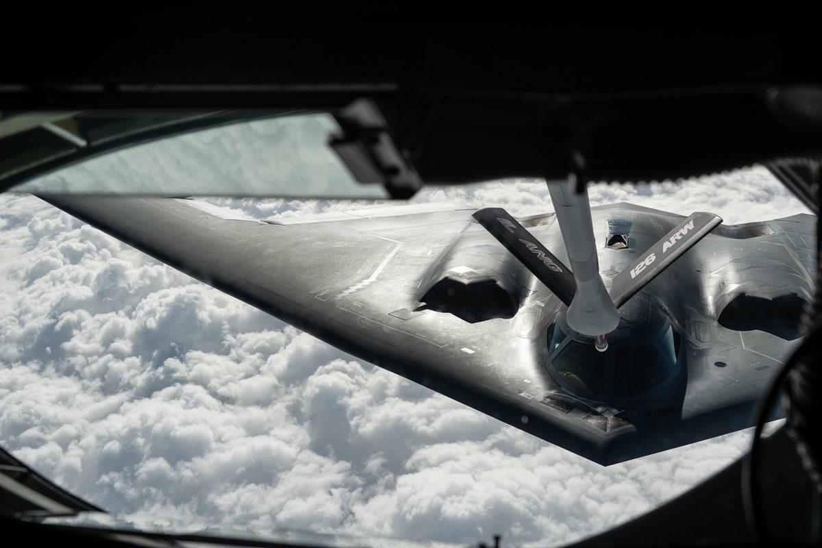 B-2 Spirit stealth bomber approaching a KC-135 tanker for aerial refueling over the ocean