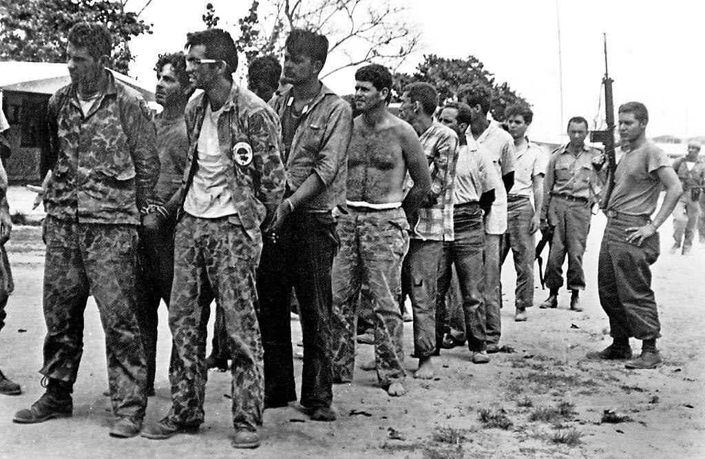 Captured members of Brigade 2506 guarded by Cuban soldiers after the failed Bay of Pigs invasion in April 1961