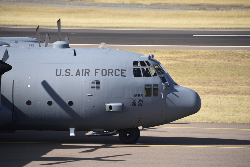 Six C-130H Hercules aircraft flying in formation over Montana