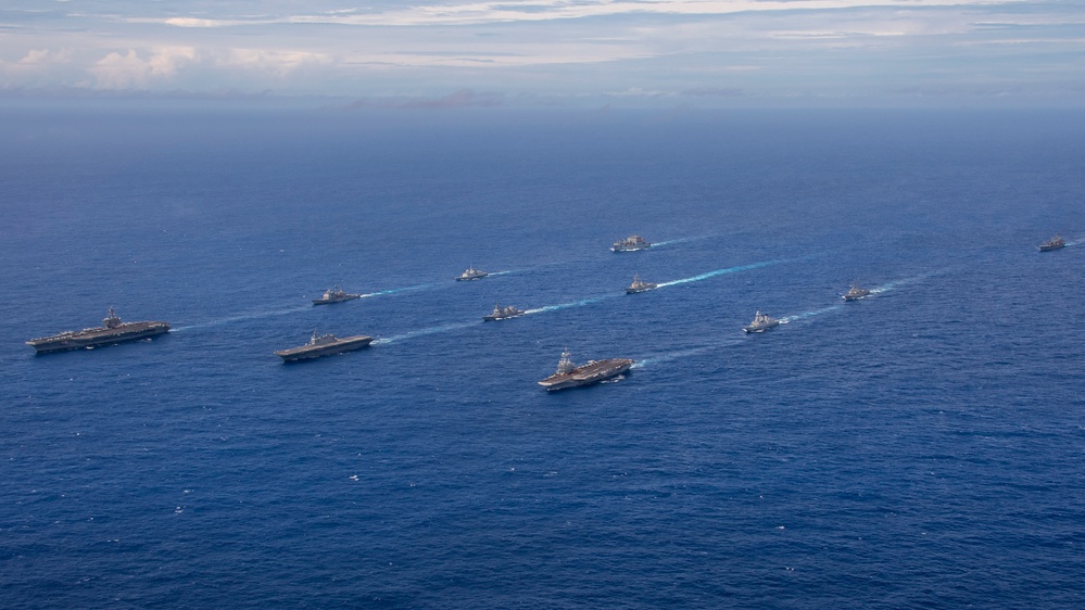 Guided missile destroyer providing air defense for carrier strike group