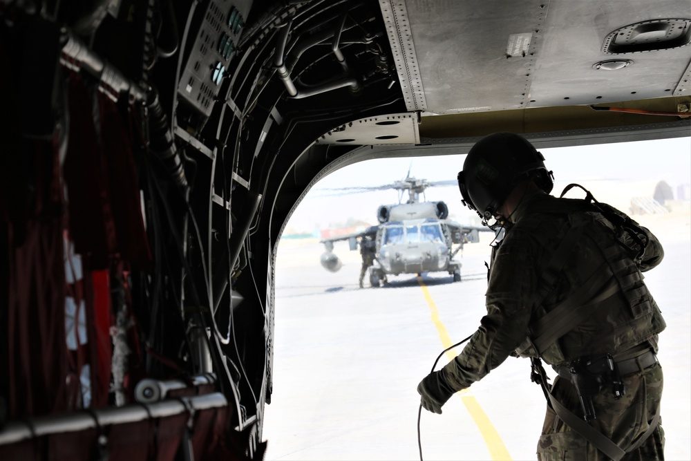 View from inside the rear cargo ramp of a CH-47 Chinook helicopter during flight operations