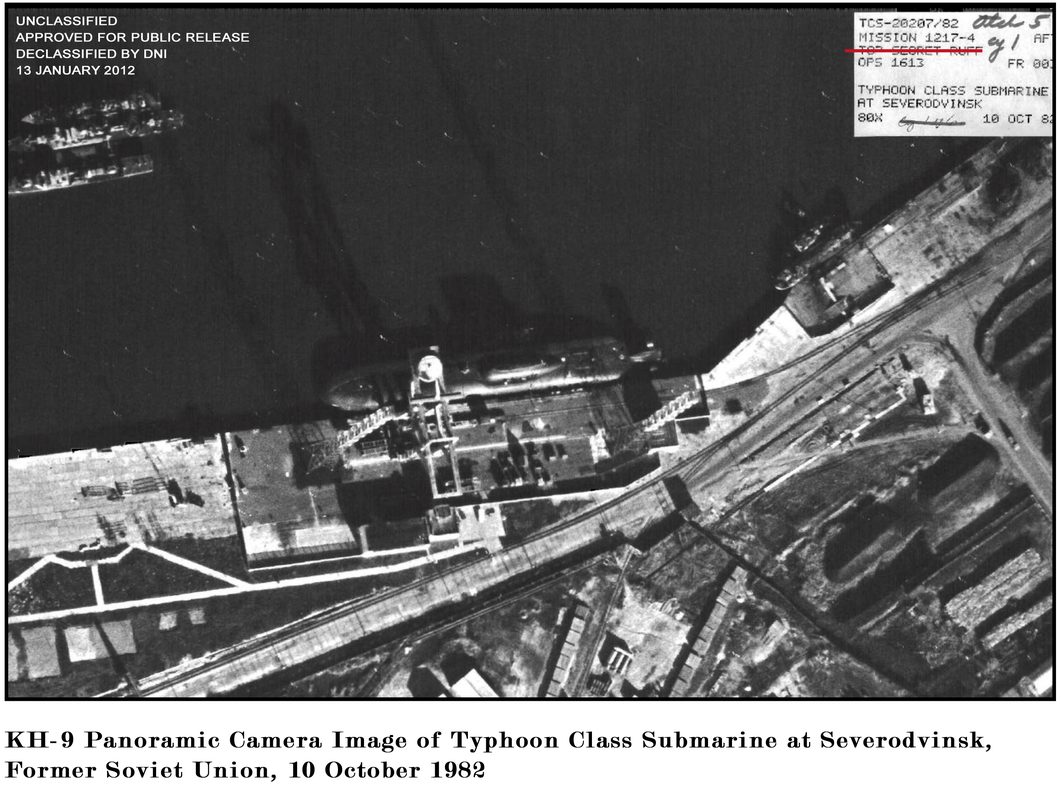 Soviet Typhoon-class ballistic missile submarine on the surface showing its massive hull dwarfing nearby vessels
