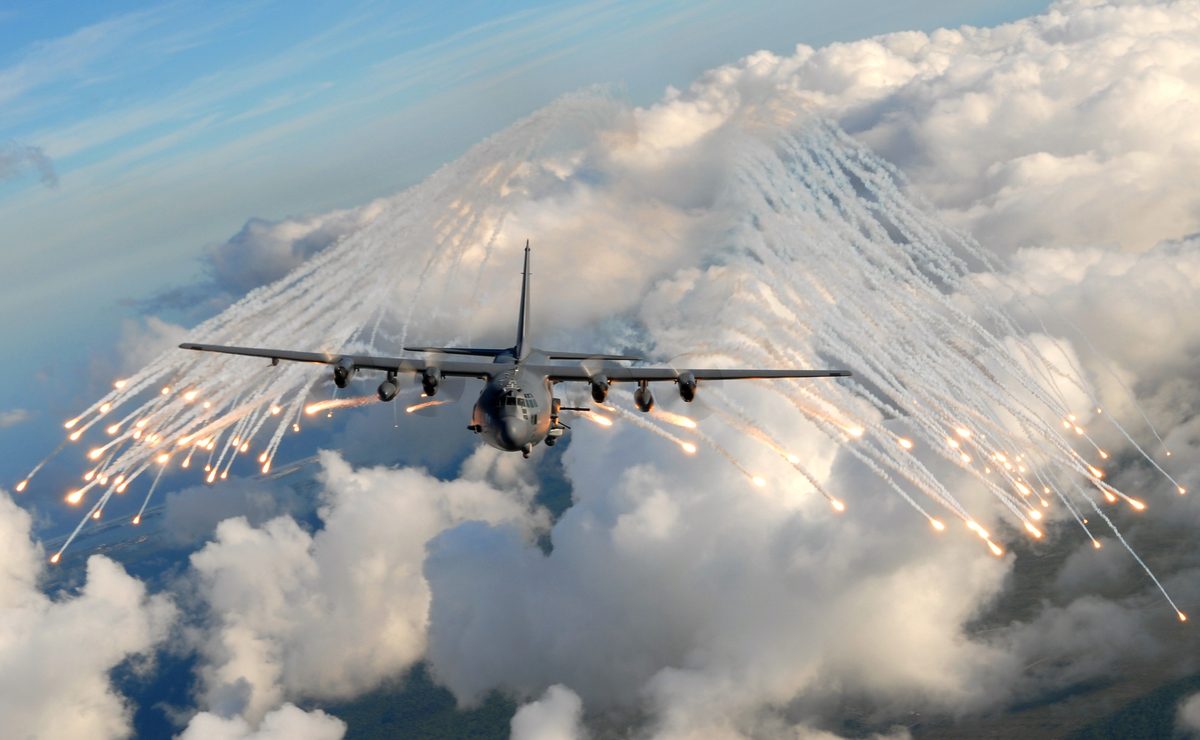 An AC-130H Spectre gunship jettisons infrared countermeasure flares during a training mission near Hurlburt Field, Florida