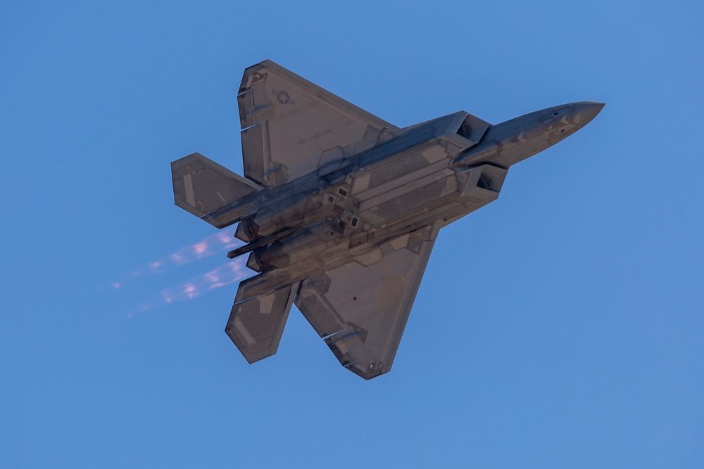 F-22 Raptor performing at an airshow demonstrating its maneuverability and thrust vectoring