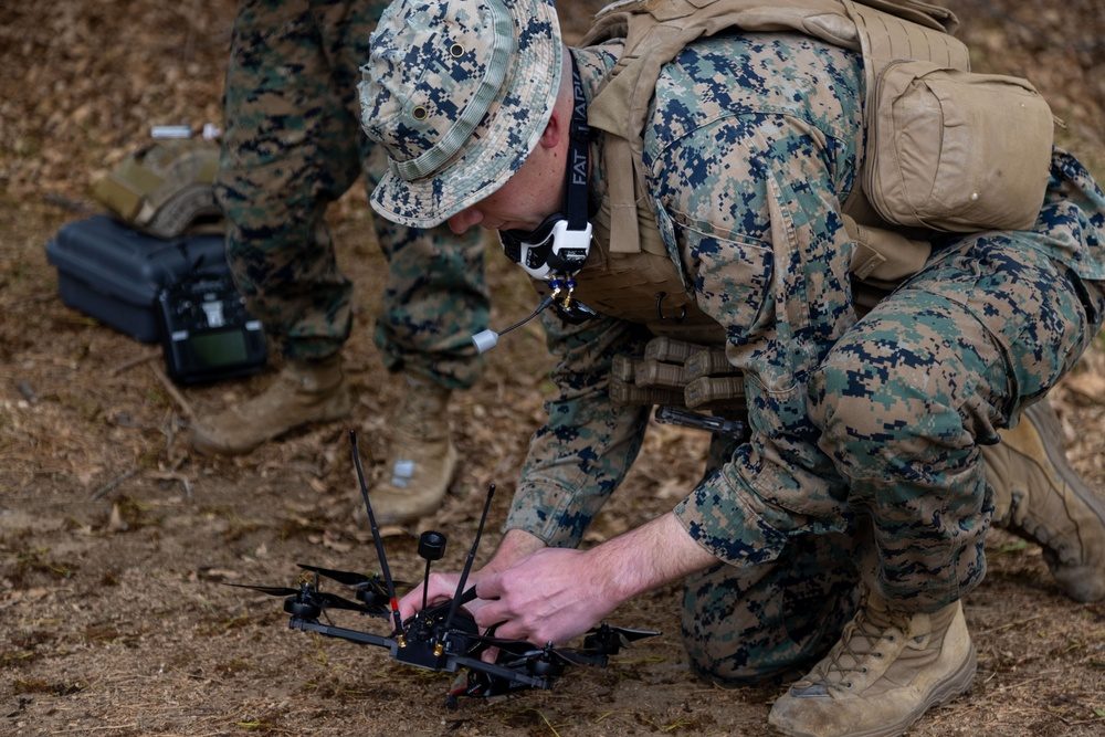 Military personnel working with a tactical FPV drone system during field operations