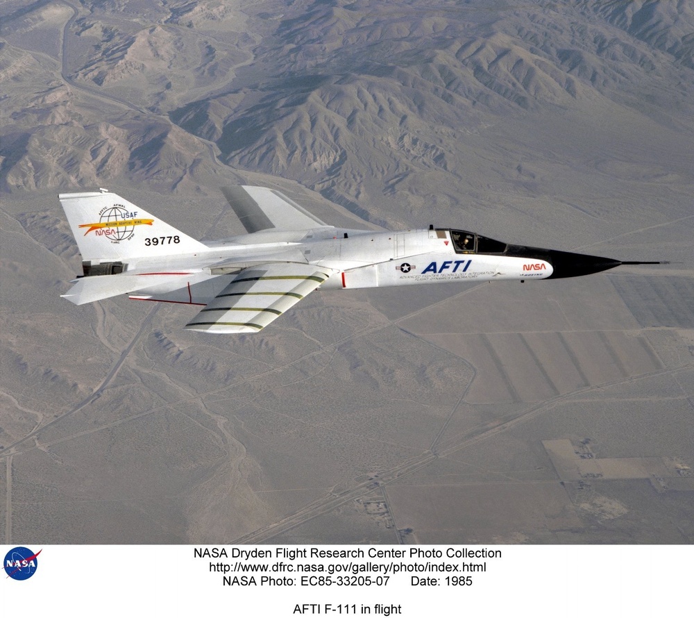 F-111 AFTI test aircraft in flight over desert terrain