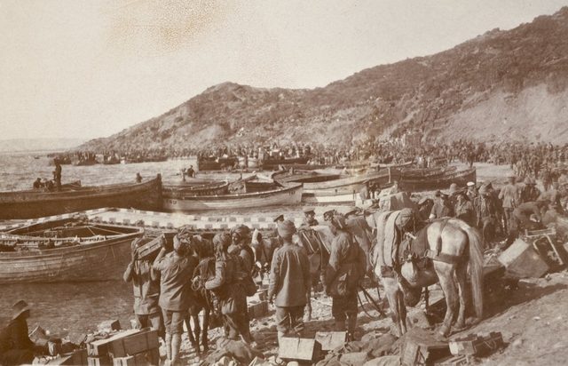 Indian and ANZAC troops crowded at Anzac Cove with supplies on the narrow beach in 1915