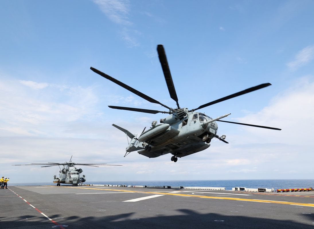 CH-53E Super Stallion heavy-lift helicopter taking off from a naval vessel flight deck