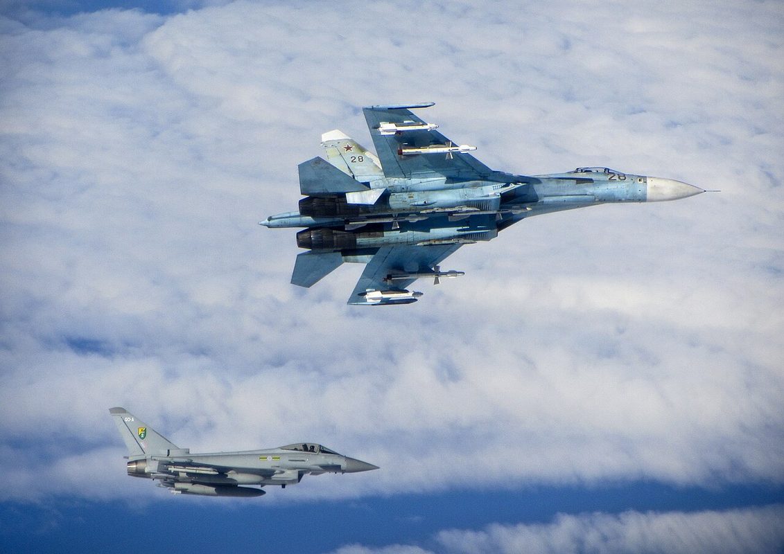 A Russian Su-27 Flanker flying alongside an RAF Typhoon, both aircraft types equipped with IRST systems