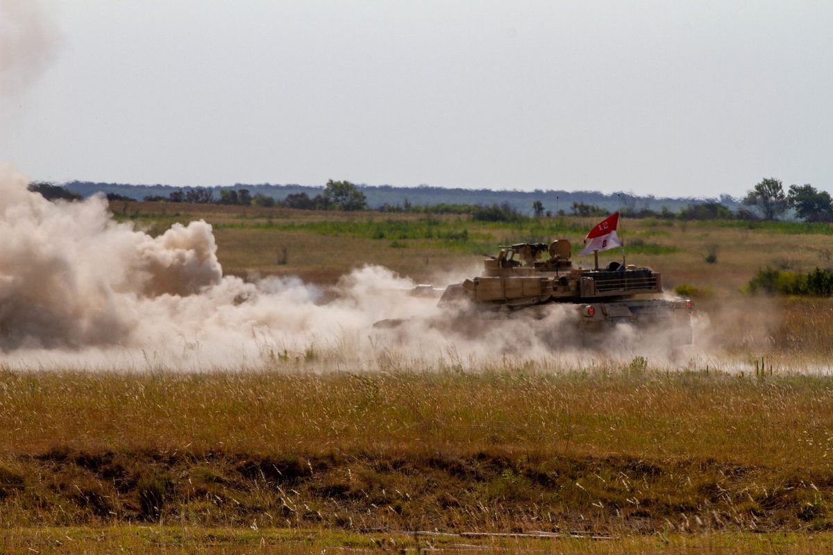 M1 Abrams main battle tank firing its 120mm main gun during live fire exercise