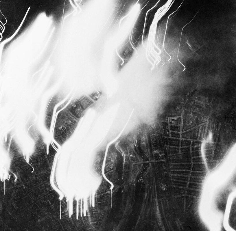 Aerial photograph of an RAF night bombing raid showing fires and target markers