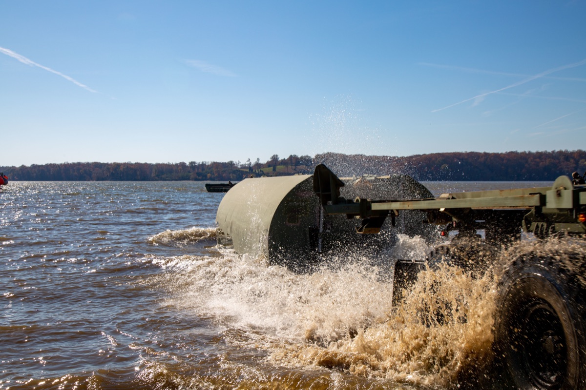 Soldiers crossing a modern Improved Ribbon Bridge during a combined arms training exercise