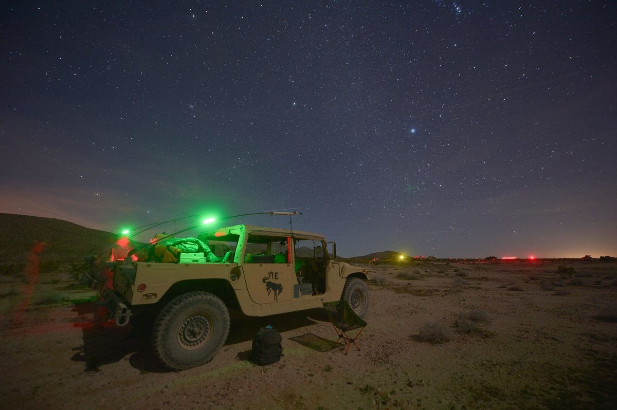 A tactical vehicle assigned to the National Training Center observer controller trainer team sits at an observation point at Fort Irwin