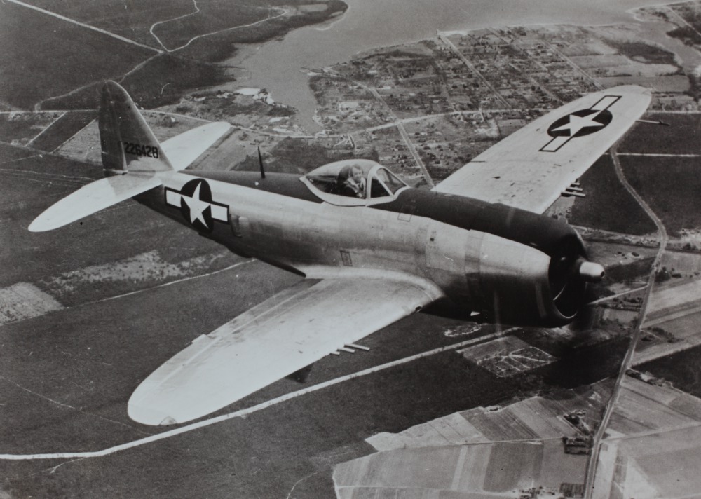 P-47 Thunderbolt in flight showing its massive profile and eight-gun wing armament during World War II