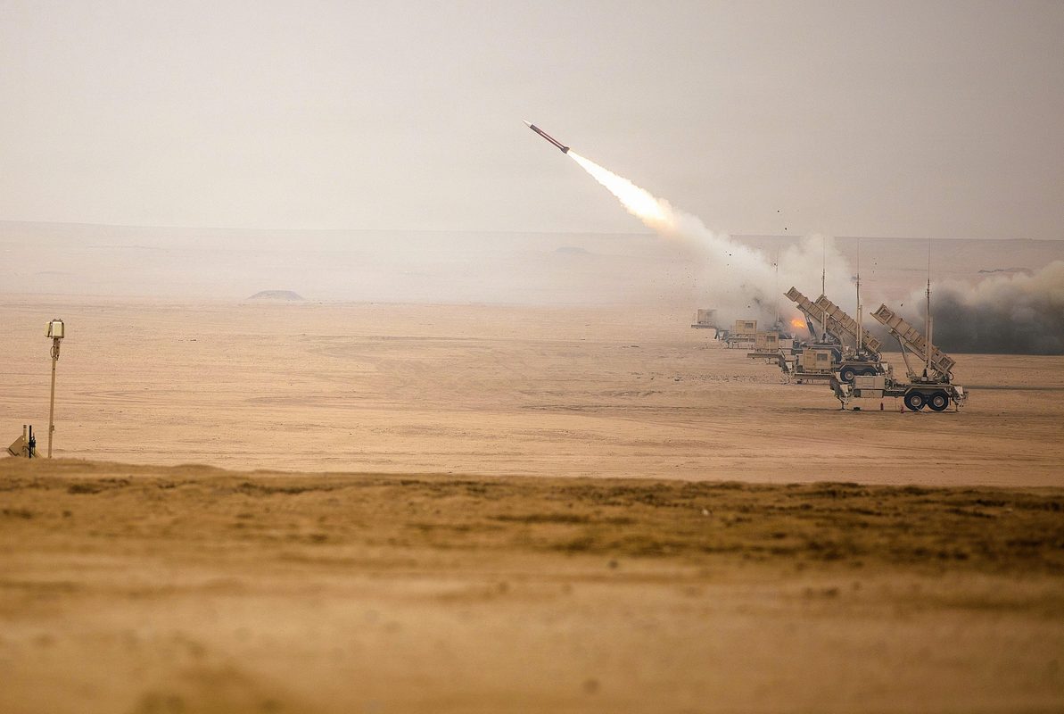 U.S. Army soldiers loading PAC-3 interceptor canisters onto a Patriot launcher during reload training