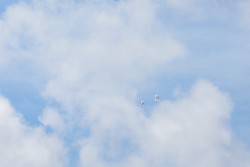 Two Patriot PAC-2 missiles intercepting a target with smoke trails visible in the sky