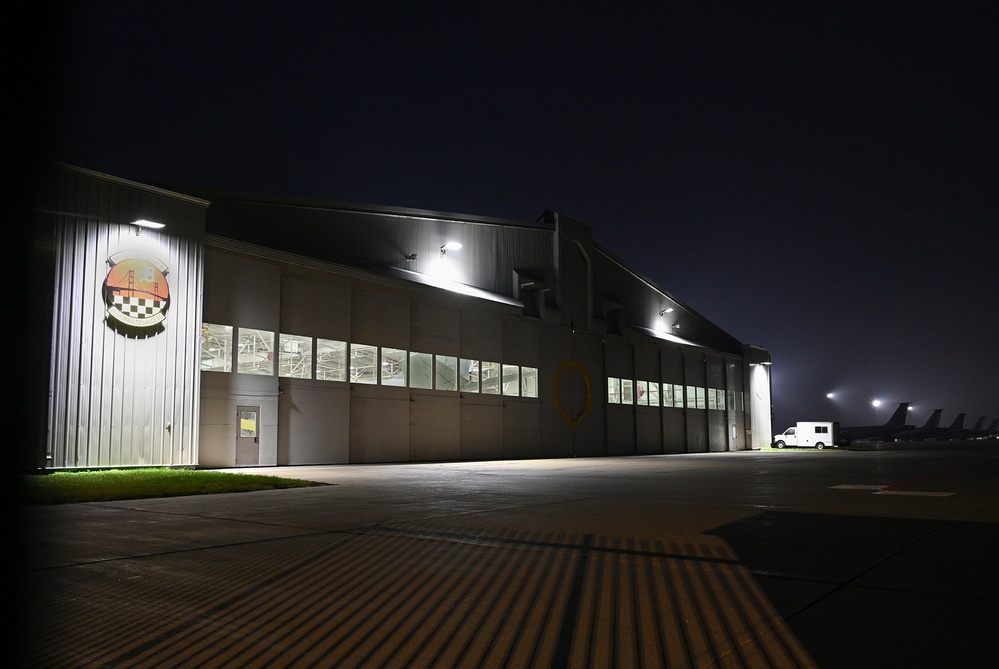 Military aircraft undergoing maintenance in a hangar facility