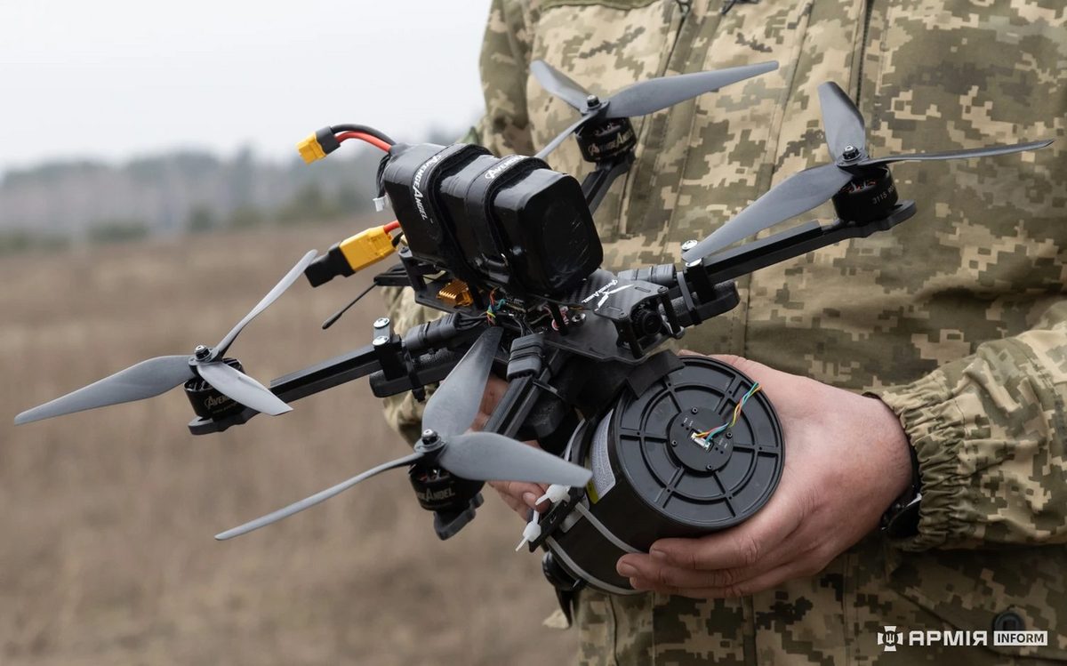 Conceptual illustration of a fiber-optic guided drone trailing a thin tether cable