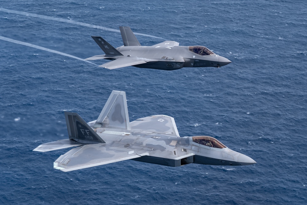 U.S. Air Force F-22 Raptor flying in formation with an F-35 Lightning II