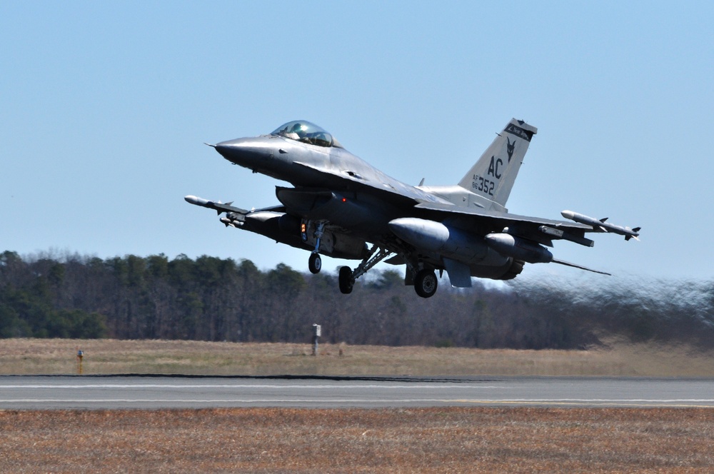 F-16 Fighting Falcon soars above clouds during operational mission