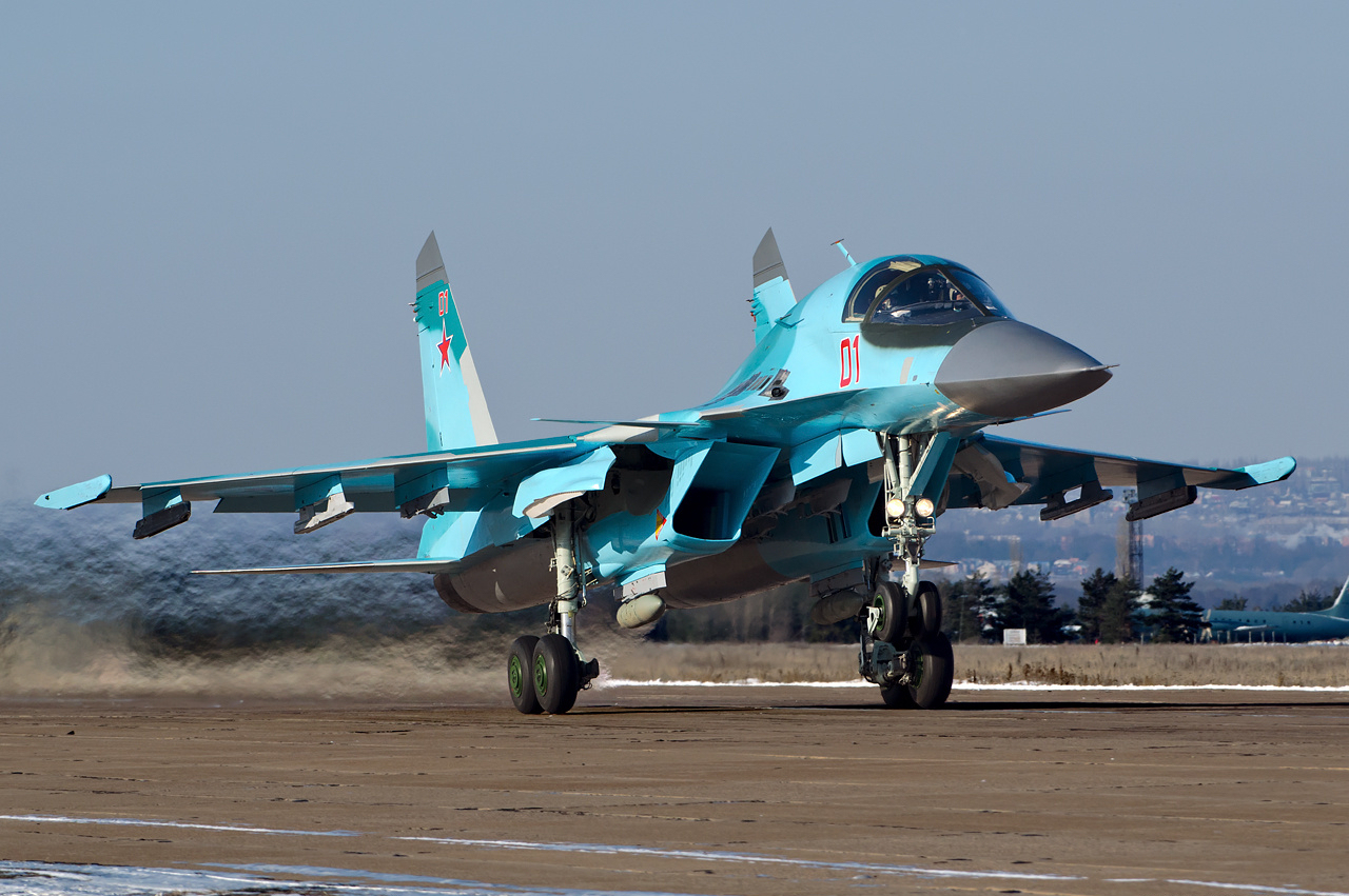 Close-up of Su-34 Fullback nose showing the distinctive flattened 'platypus' shape housing the side-by-side cockpit
