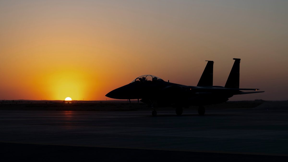 F-15E Strike Eagle preparing for takeoff during sunset at an undisclosed location in Southwest Asia